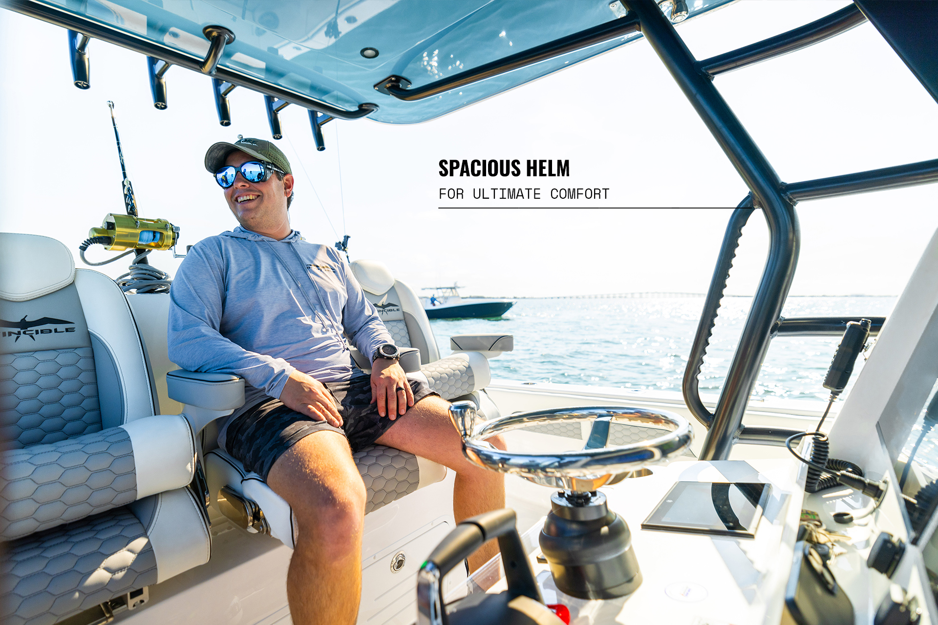 Man smiling at helm of 36 Catamaran